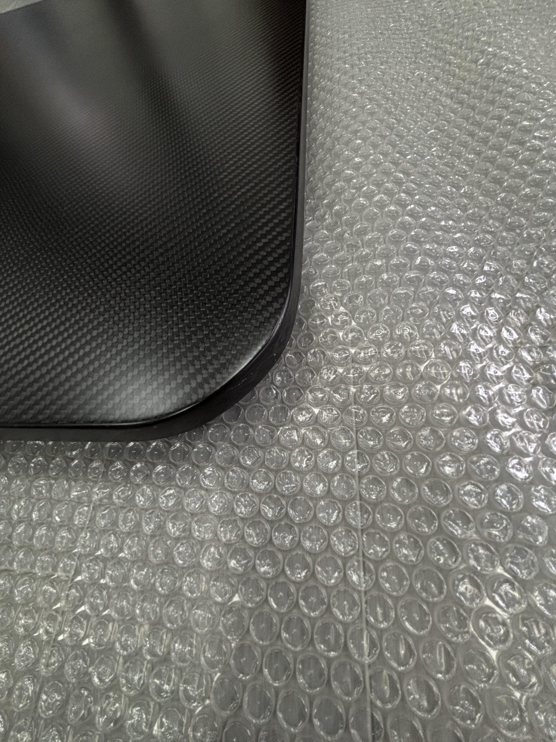 Alt-Text: Technician at E-YOUNG Composites applying carbon fiber laminate for edge banding